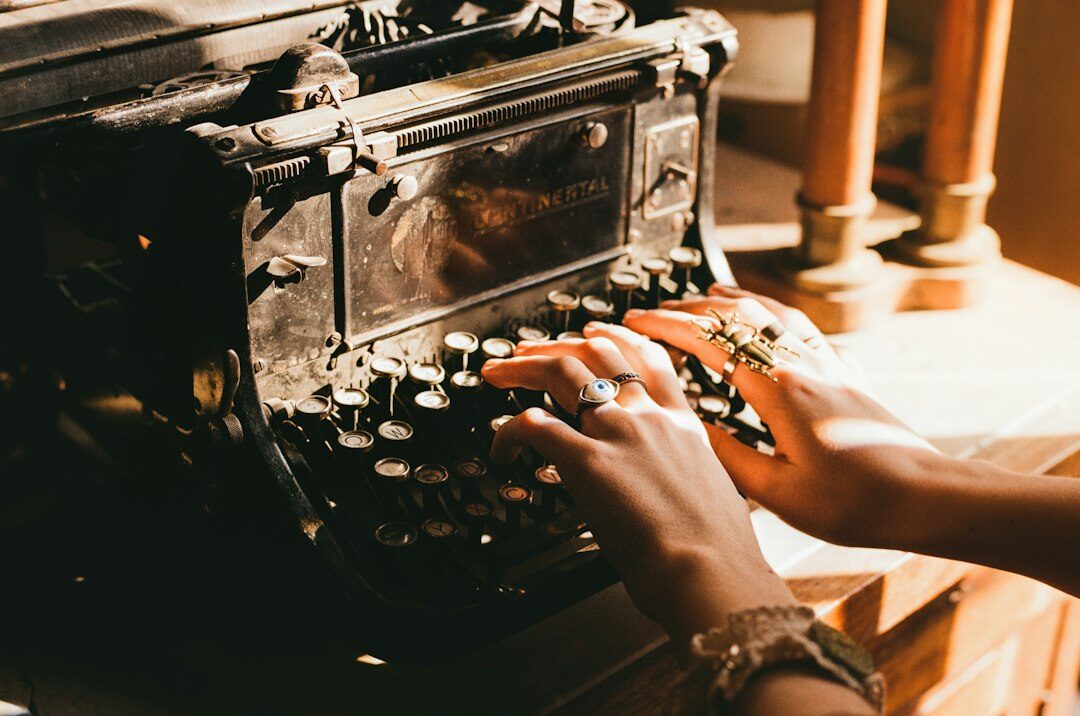 writer typing on old typewriter